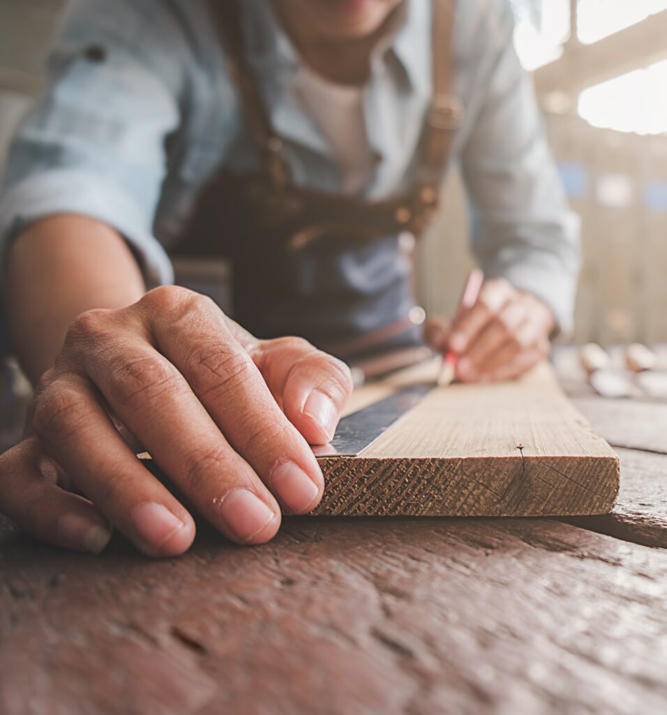 Carpenter working with equipment on wooden table in carpentry shop. woman works in a carpentry shop.